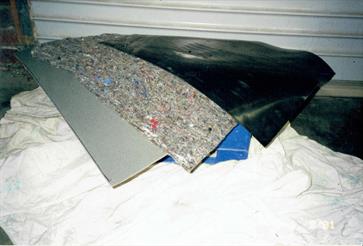 The three "modern" materials used to make the “sound sandwich” for under the carpet.  Ribbed rubber mat, felt and a dense water resistant foam.  This resulted in improved sound insulation and prevention of moisture retention against the floors.